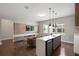 Entertainers space with a wet bar, waterfall countertop, and a full living room at 10529 Royal Cypress Way, Orlando, FL 32836