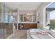 Main bathroom featuring a soaking tub, walk-in shower and double sink vanity at 10529 Royal Cypress Way, Orlando, FL 32836