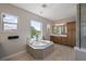 Tranquil main bathroom with a soaking tub, large window, and walk-in shower at 10529 Royal Cypress Way, Orlando, FL 32836