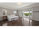 Main bedroom boasts beautiful flooring, tray ceiling, and access to a private balcony with a lake view at 10529 Royal Cypress Way, Orlando, FL 32836