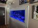 Unique built-in aquarium with colorful fish, adding a distinctive design element to the home's interior at 1112 Winding Water Way, Clermont, FL 34714