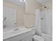 The bathroom features a shower-tub combo with a shower curtain, a toilet, and a white sink and vanity at 1112 Winding Water Way, Clermont, FL 34714