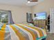 Inviting bedroom with neutral walls, a ceiling fan, and plenty of natural light through the window at 1112 Winding Water Way, Clermont, FL 34714