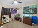 ' room featuring playful wall decor, two fish tanks, and carpeted flooring at 1112 Winding Water Way, Clermont, FL 34714