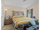 Bright bedroom with a large bed, two nightstands and carpeted flooring, offering comfort and relaxation at 1112 Winding Water Way, Clermont, FL 34714