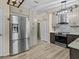 Modern kitchen showcasing stainless steel appliances, including a large refrigerator and stylish cabinetry at 1112 Winding Water Way, Clermont, FL 34714