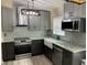 Modern kitchen featuring sleek cabinets, stainless steel appliances, granite countertops, and a stylish backsplash at 1112 Winding Water Way, Clermont, FL 34714