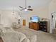 Spacious living room with plush carpet, high ceilings, ceiling fan, and comfortable furnishings at 1112 Winding Water Way, Clermont, FL 34714