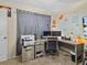 Functional home office featuring a printer, desk, dual monitors, neutral wall paint and carpeted flooring at 1112 Winding Water Way, Clermont, FL 34714