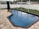 Relaxing in-ground swimming pool with a brick paver surround and screened enclosure, offering a private retreat at 1112 Winding Water Way, Clermont, FL 34714