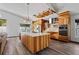 Modern kitchen with stainless appliances, quartz countertops and wood cabinets at 11836 Hartfordshire Way, Orlando, FL 32824