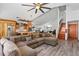 Open-concept living room flows into the kitchen and features wood floors and a stylish ceiling fan at 11836 Hartfordshire Way, Orlando, FL 32824