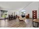 Bright living room boasts hardwood floors, a vaulted ceiling, lots of natural light, and modern decor at 11836 Hartfordshire Way, Orlando, FL 32824