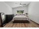 Spacious main bedroom featuring a ceiling fan, a large window and wood plank floors at 11836 Hartfordshire Way, Orlando, FL 32824