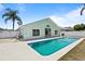 Backyard featuring a pool and hot tub, surrounded by lush landscaping and privacy fence at 11836 Hartfordshire Way, Orlando, FL 32824