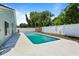 An outdoor pool with a white surrounding deck is enclosed by a white privacy fence at 11836 Hartfordshire Way, Orlando, FL 32824