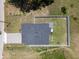 Aerial view of a home showcasing a backyard with a well maintained lawn and a full perimeter fence at 146 E 15Th St, Apopka, FL 32703