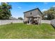 The backyard has a well-maintained lawn, a pergola and a full privacy fence at 146 E 15Th St, Apopka, FL 32703