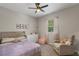 Cozy bedroom featuring a soft bed, a charming rocking chair, and delightful decor for a haven at 146 E 15Th St, Apopka, FL 32703