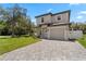 Charming two-story home with a well-maintained front yard and a brick-paved driveway leading to the garage at 146 E 15Th St, Apopka, FL 32703