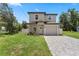 Charming two-story home with well-maintained landscaping and brick driveway at 146 E 15Th St, Apopka, FL 32703