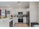 Modern kitchen with stainless steel appliances, white cabinets, and quartz countertops, offering a sleek design at 146 E 15Th St, Apopka, FL 32703