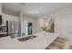 Bright open kitchen with quartz island, stainless appliances, seating and stairs leading to the second floor at 146 E 15Th St, Apopka, FL 32703