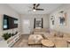 Cozy living room featuring a comfortable sectional sofa, TV, neutral decor, and ample natural light at 146 E 15Th St, Apopka, FL 32703