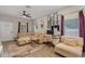Comfortable living room featuring a sectional sofa, desk area, neutral decor, and plenty of natural light at 146 E 15Th St, Apopka, FL 32703