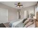 Spacious main bedroom with ensuite bathroom access, carpet and ceiling fan at 146 E 15Th St, Apopka, FL 32703