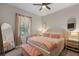 Charming bedroom with a ceiling fan, plush bedding, and well-lit nightstands, creating a cozy retreat at 146 E 15Th St, Apopka, FL 32703