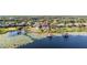 An aerial view captures a residential area featuring lake access, private docks, and well-manicured lawns at 14724 Avenue Of The Rushes, Winter Garden, FL 34787
