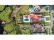 Expansive aerial view showcases the stunning home, pool, landscaped yard and waterfront access at 14724 Avenue Of The Rushes, Winter Garden, FL 34787