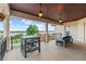 Spacious covered balcony featuring an outdoor dining area with views of the lake and beautiful landscape at 14724 Avenue Of The Rushes, Winter Garden, FL 34787
