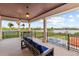 Expansive covered balcony with comfortable seating and views of the pool, lake, and palm trees at 14724 Avenue Of The Rushes, Winter Garden, FL 34787