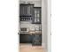 Stylish bar area with dark cabinets, a countertop, glassware storage, and modern appliances at 14724 Avenue Of The Rushes, Winter Garden, FL 34787