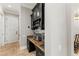 Elegant butler's pantry with dark cabinetry, stone countertop, and stylish stemware display at 14724 Avenue Of The Rushes, Winter Garden, FL 34787