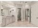 Bathroom with a granite countertop vanity, tiled floor, and doorways leading to the toilet and other rooms at 14724 Avenue Of The Rushes, Winter Garden, FL 34787
