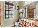 Elegant bathroom featuring warm tones, tiled walls, a granite countertop, and a framed window view at 14724 Avenue Of The Rushes, Winter Garden, FL 34787