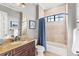 Bathroom features a vanity with marble counter and a tub-shower with tan tile at 14724 Avenue Of The Rushes, Winter Garden, FL 34787