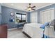 Bright bedroom with neutral carpet, blue walls, and a window with lake view at 14724 Avenue Of The Rushes, Winter Garden, FL 34787