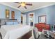 Well-lit bedroom with blue accent wall and a door leading to the terrace at 14724 Avenue Of The Rushes, Winter Garden, FL 34787