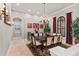 Elegant dining room features a large table, chandelier, and windows for natural light at 14724 Avenue Of The Rushes, Winter Garden, FL 34787