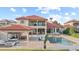 Elegant two-story home featuring a red tile roof, large pool, cabana, and lush landscaping at 14724 Avenue Of The Rushes, Winter Garden, FL 34787