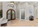 Grand foyer with ornate double doors, high ceilings, travertine floors, and elegant details at 14724 Avenue Of The Rushes, Winter Garden, FL 34787