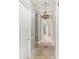 Elegant hallway with chandelier, mosaic tile inlay, and a view to another hallway at 14724 Avenue Of The Rushes, Winter Garden, FL 34787
