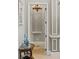 Elegant hallway with decorative trim, chandelier, and view to the formal entry at 14724 Avenue Of The Rushes, Winter Garden, FL 34787