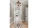 Bright hallway featuring decorative floor tile and a view to the primary bedroom suite at 14724 Avenue Of The Rushes, Winter Garden, FL 34787