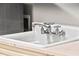 Laundry room sink with white basin, classic faucet, and neutral toned cabinets at 14724 Avenue Of The Rushes, Winter Garden, FL 34787