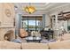 Stunning living room boasts a fireplace, piano, and panoramic views of the lake at 14724 Avenue Of The Rushes, Winter Garden, FL 34787